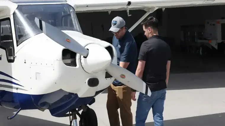 Instructor and student with the training aircraft