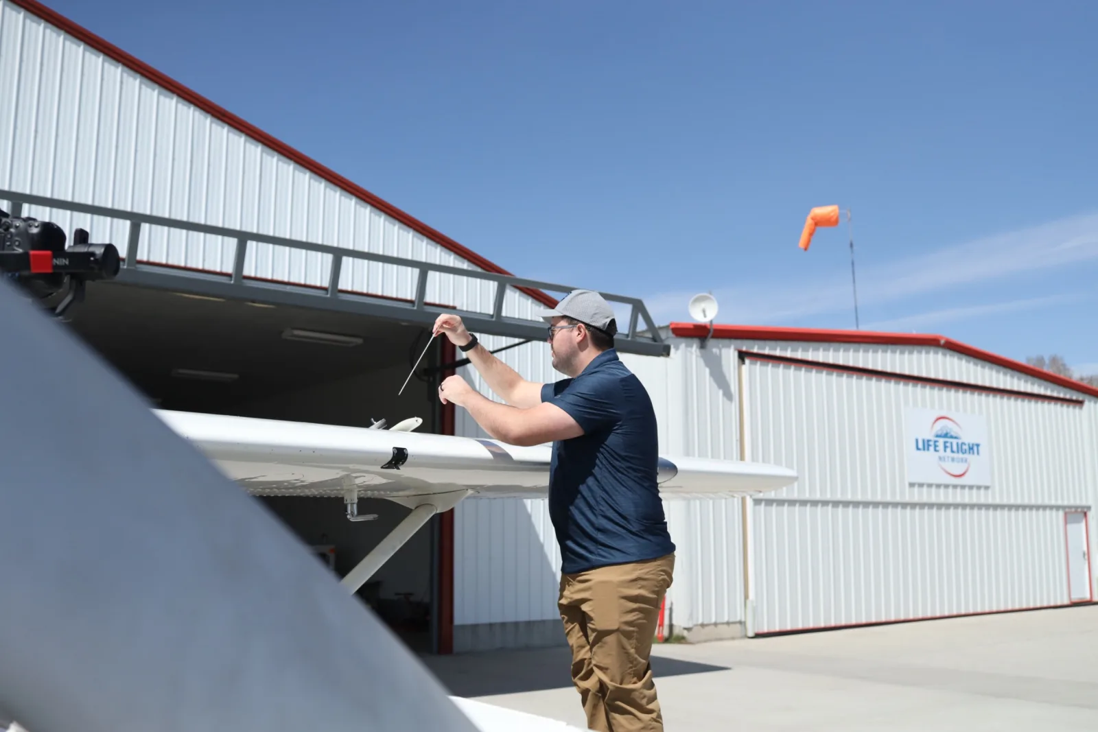 Student performing a preflight inspection at the wing