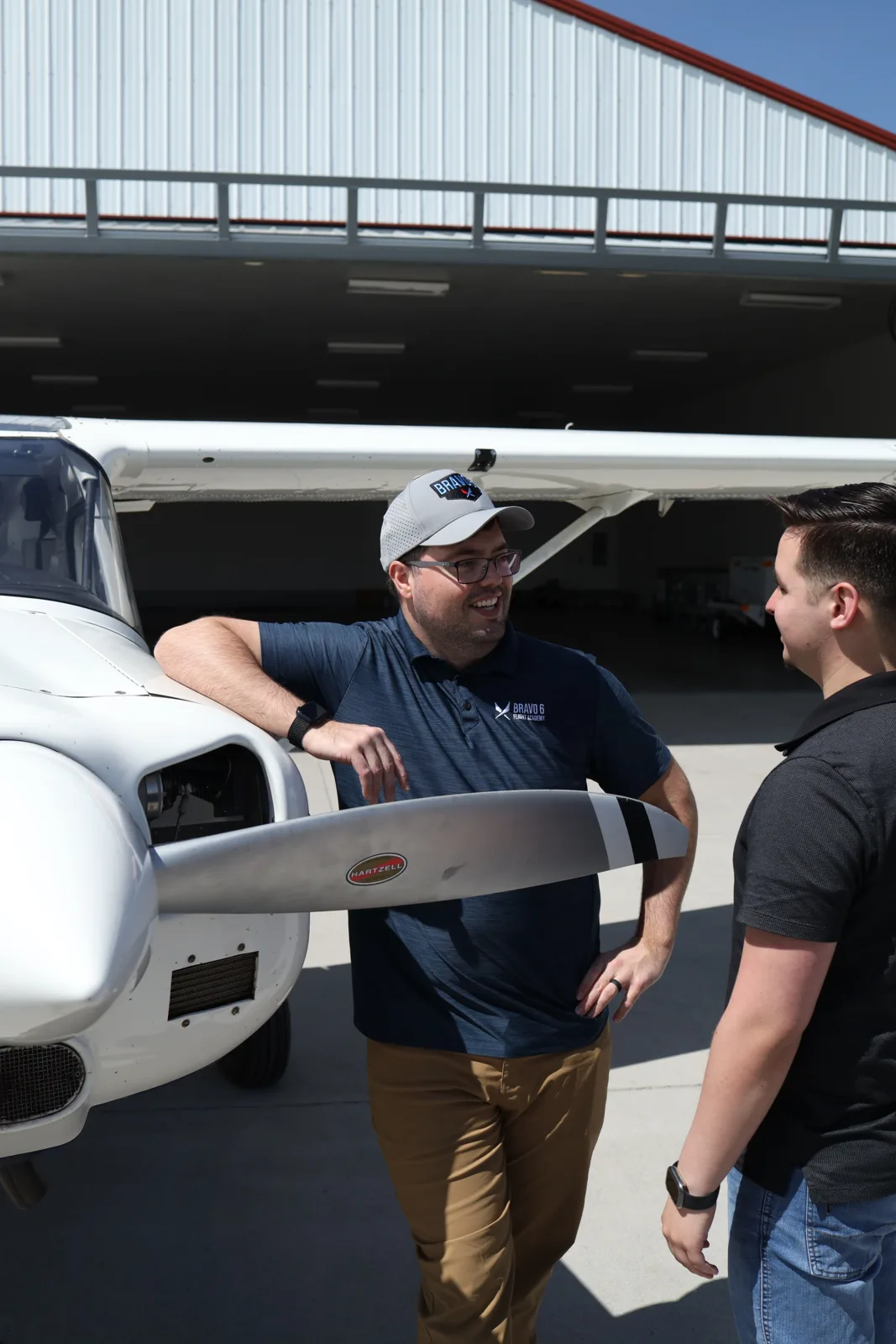 Instructor and student by the propeller