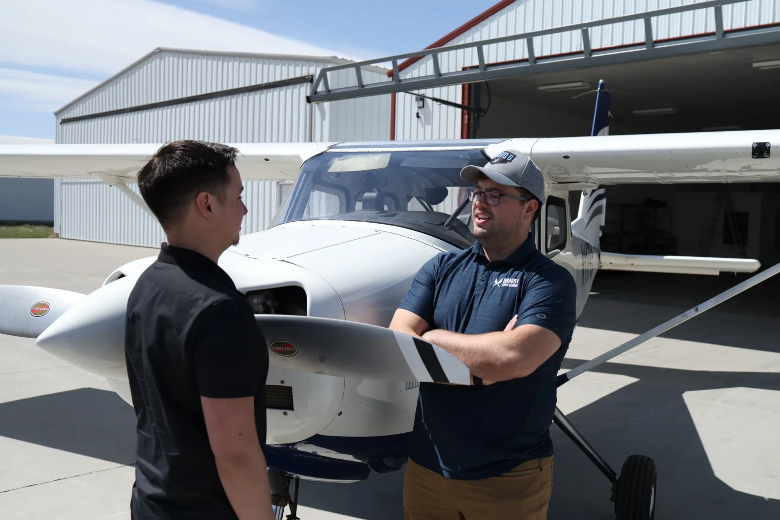 Instructor and student talking beside the aircraft
