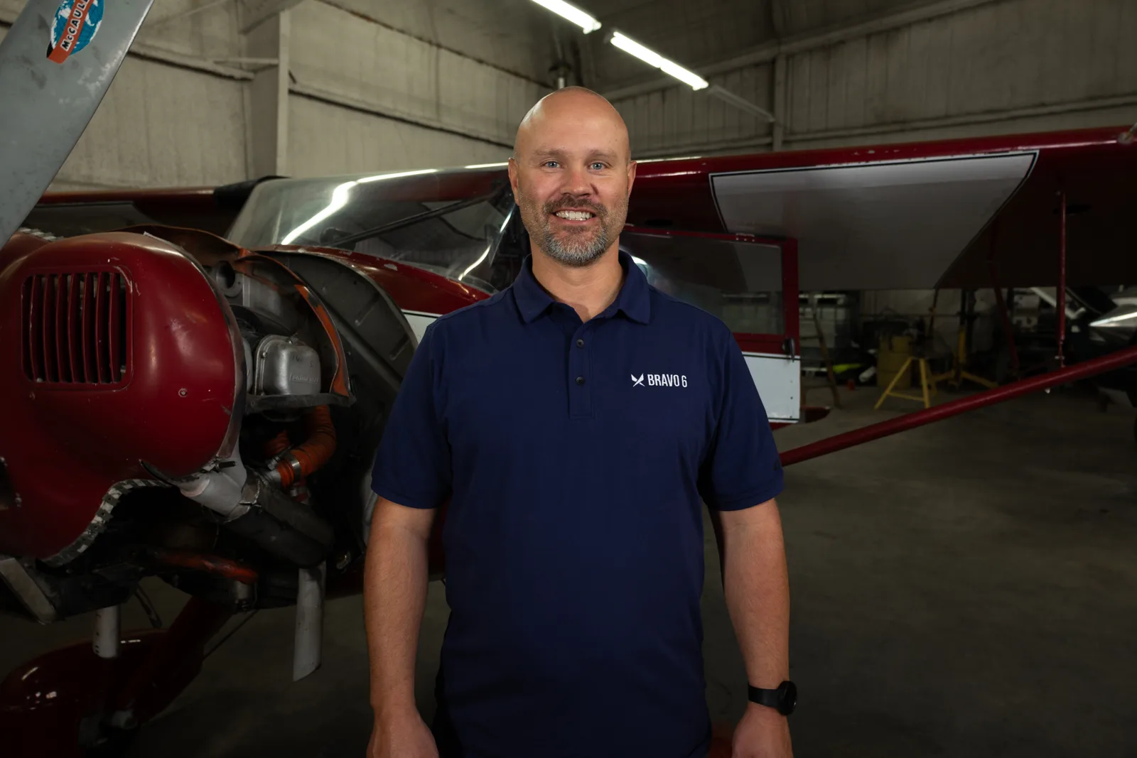 Instructor beside an aircraft engine in the hangar