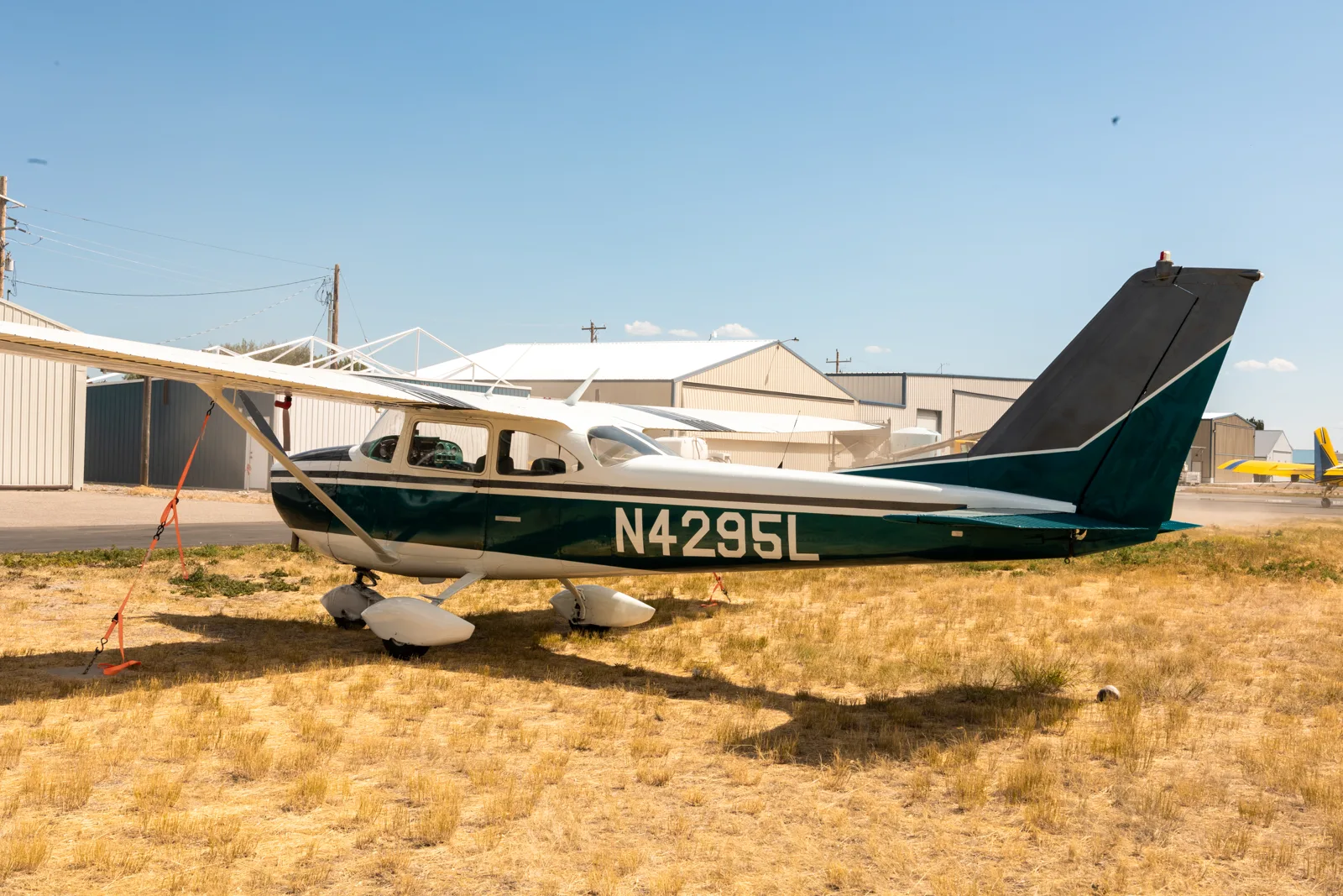 Vintage green Cessna on a grass field