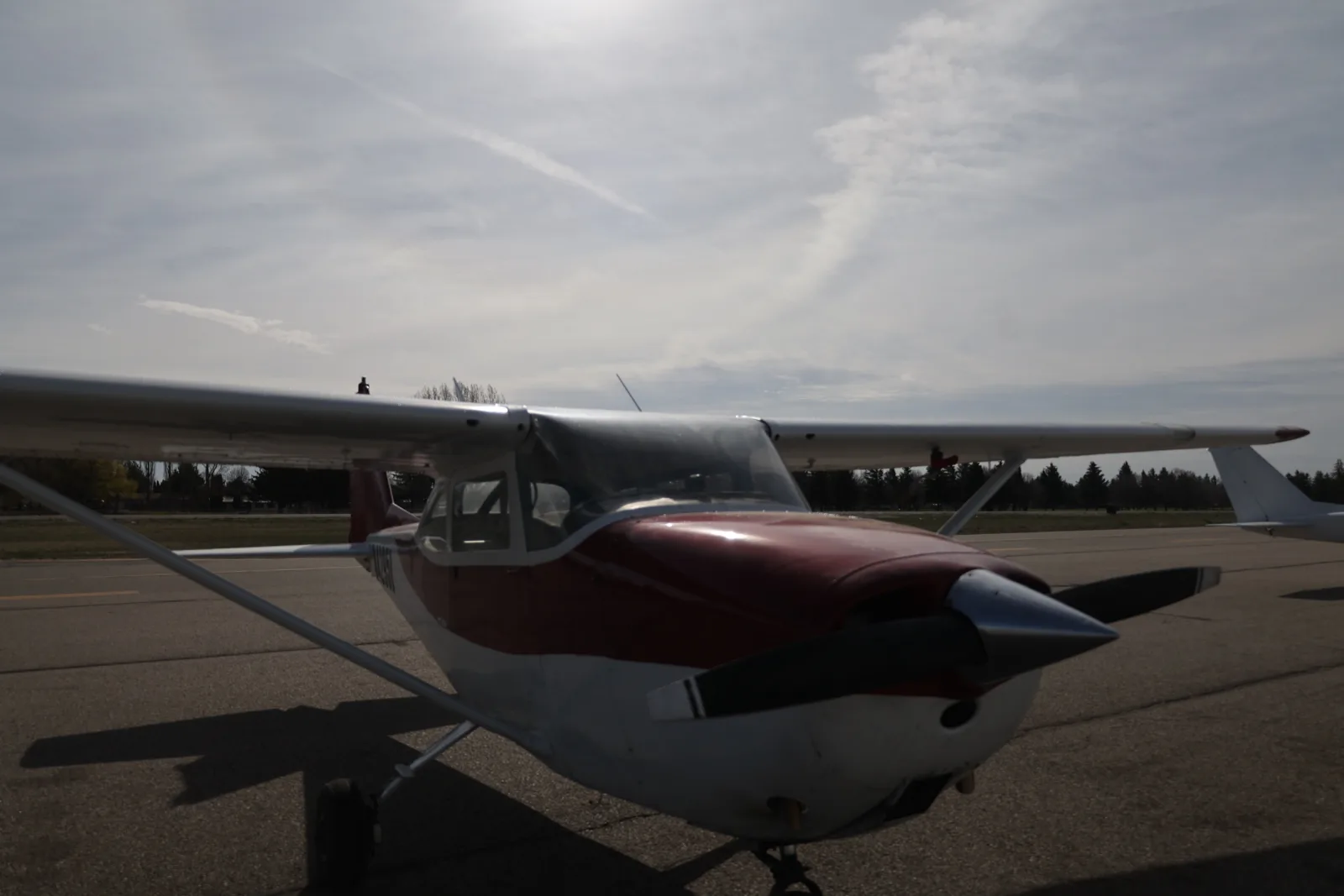 Red and white Cessna 172, three-quarter view