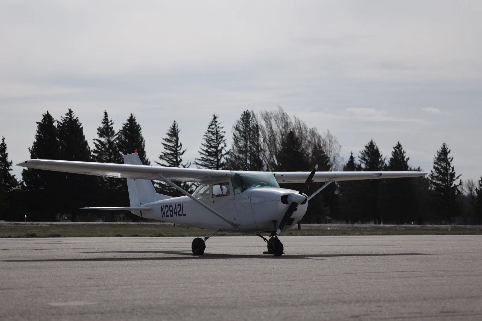 Cessna 172 on the ramp with a treeline