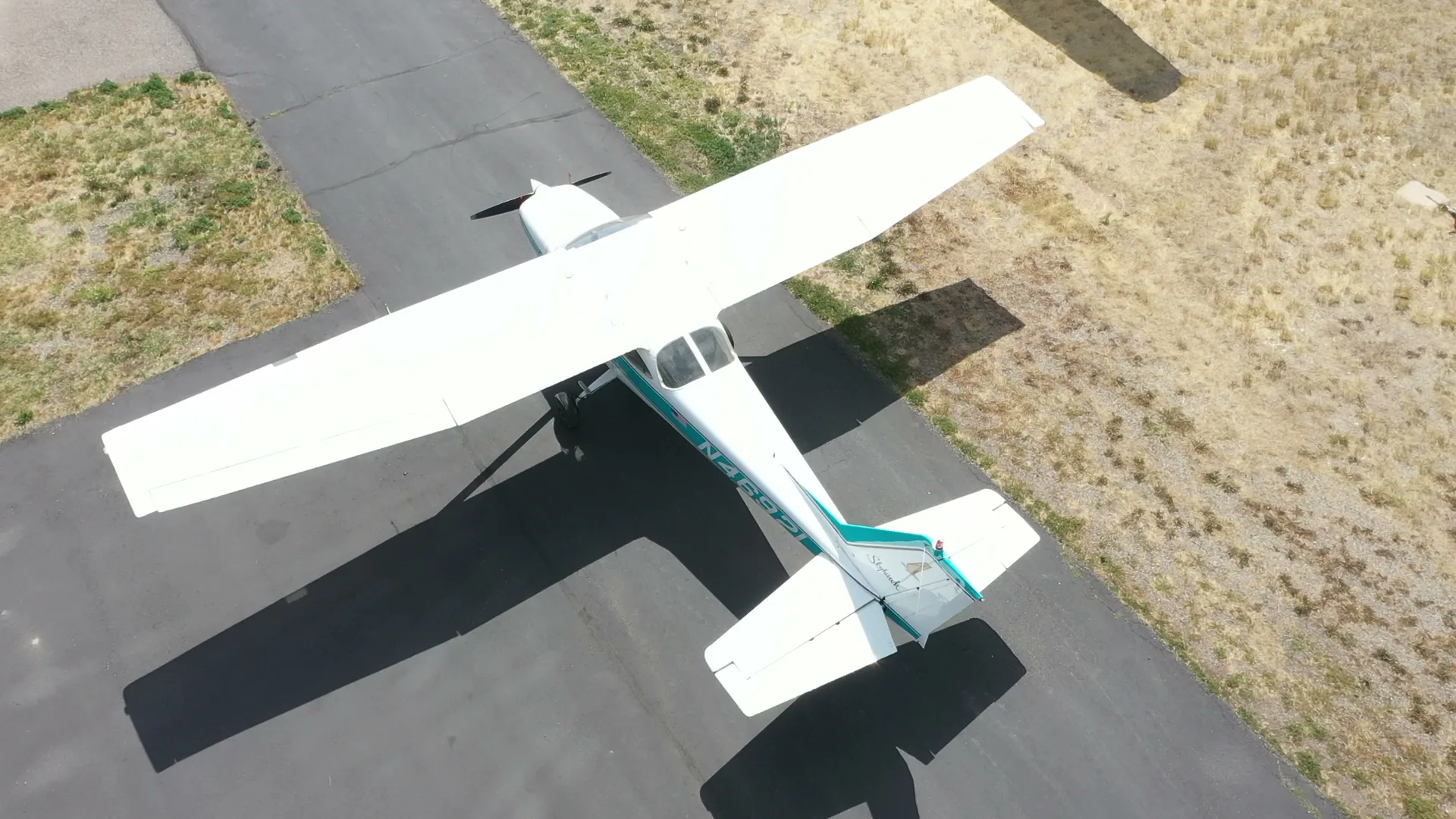 Top-down aerial of a Cessna Skyhawk on the taxiway