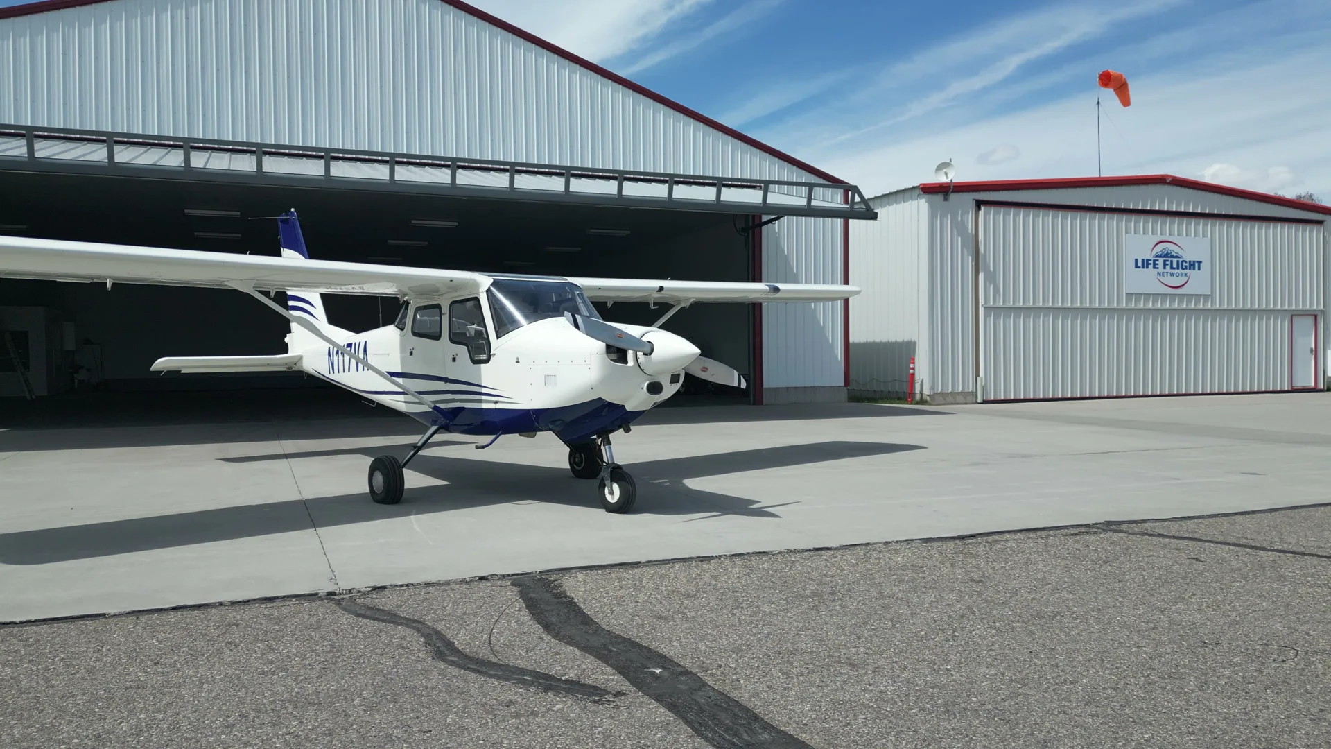 Aerial of a Bravo 6 aircraft at an open hangar bay