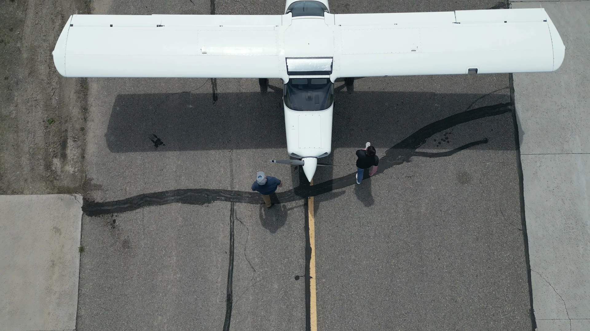 High-angle aerial of a Bravo 6 aircraft with crew at the nose