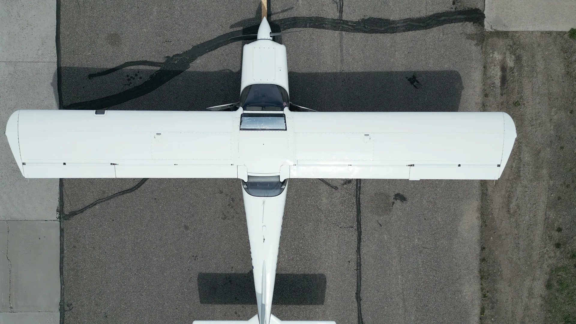 Overhead top-down aerial of a Bravo 6 trainer on the taxiway